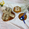 Sacred sage sticks for smudging and purification, with crystal pyramid and blue evil eye protection charm